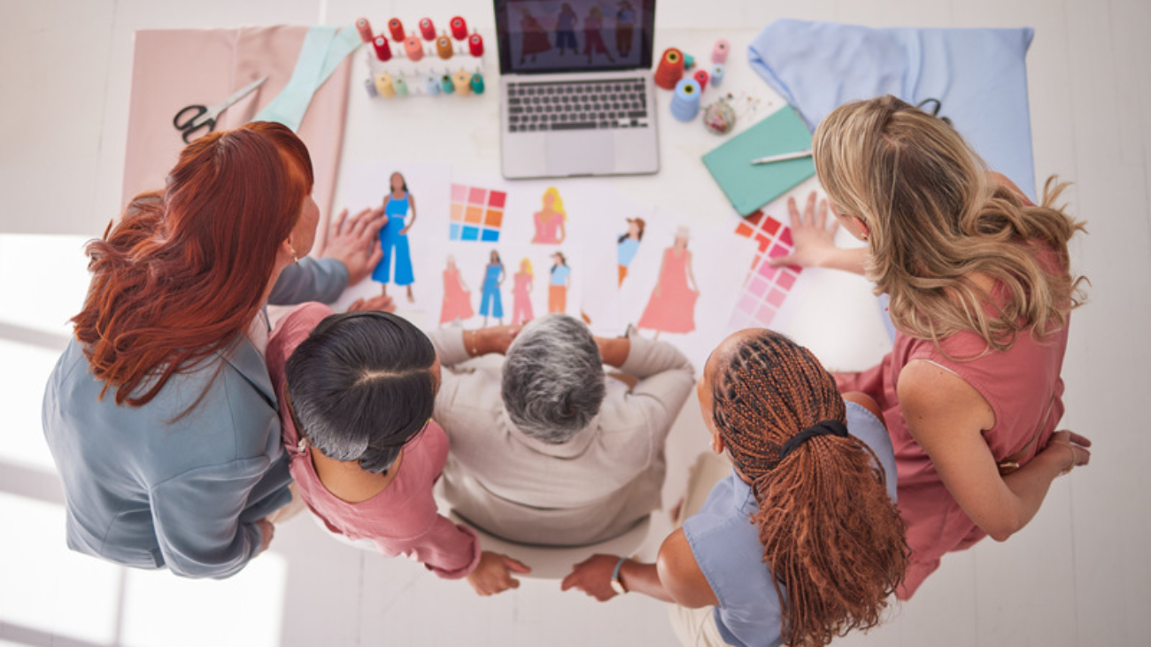 Creative business people, fashion and design above in meeting for planning, collaboration or decisi.