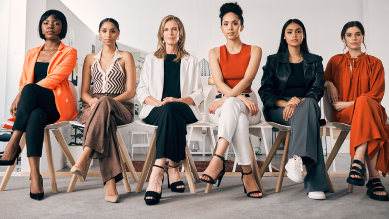 Shot of a group of businesswomen sitting in a row in an office at work.